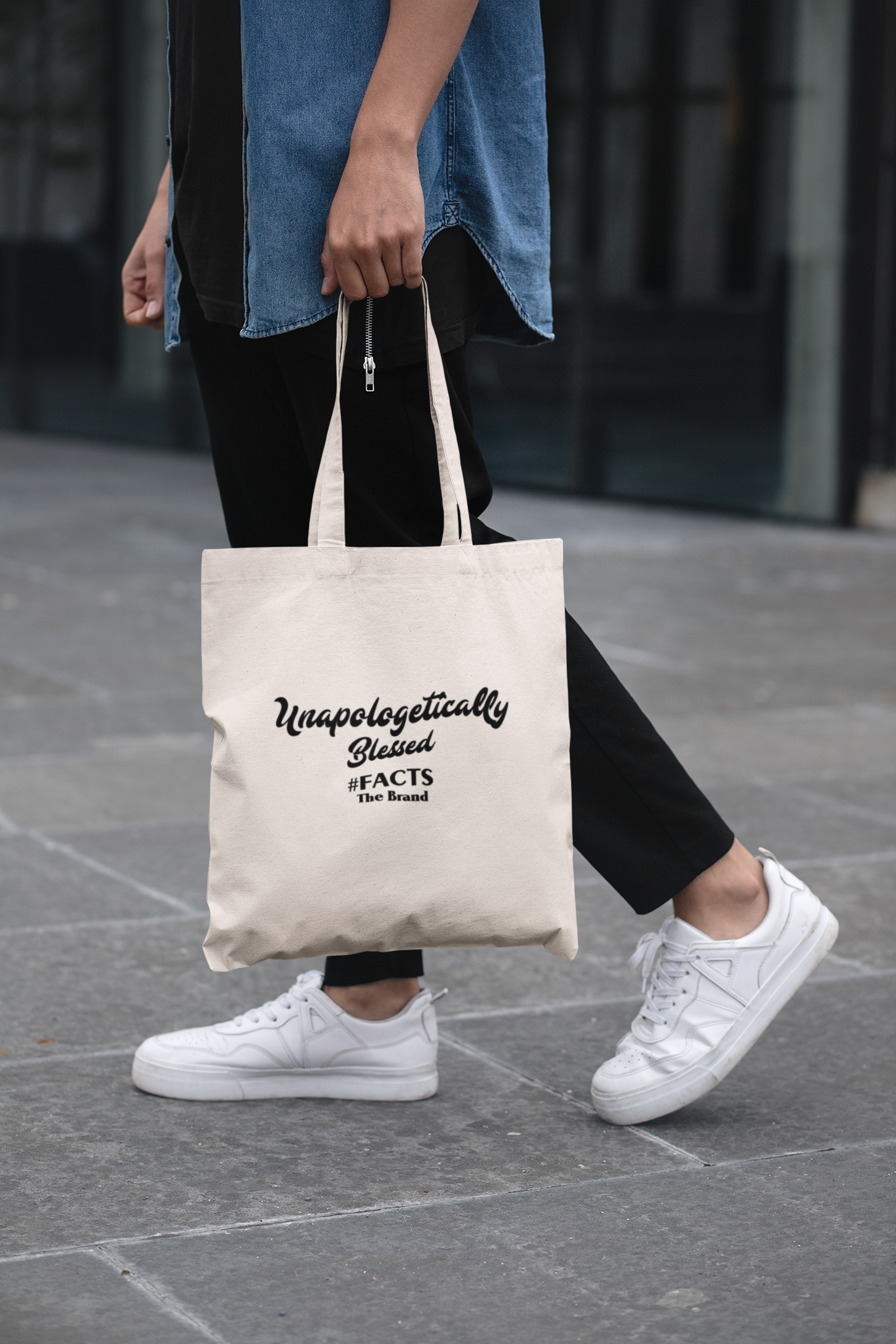 cropped-face-mockup-of-a-man-holding-a-tote-bag-in-the-street-29424 (1)